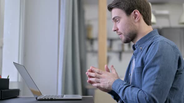 Beard Young Man Doing Video Chat on Laptop