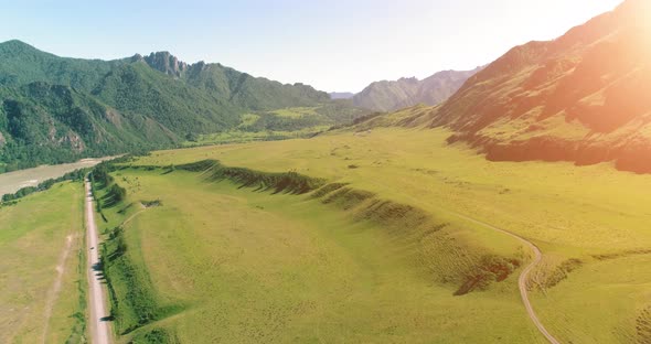 Aerial Rural Mountain Road and Meadow at Sunny Summer Morning