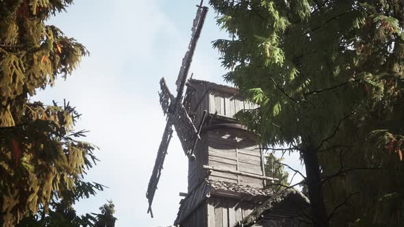Old Traditional Wooden Windmill in the Forest alt
