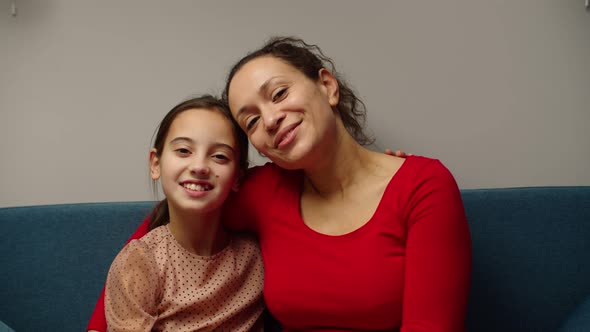 Multiethnic Mother Giving Affectionate Embrace to Daughter at Home