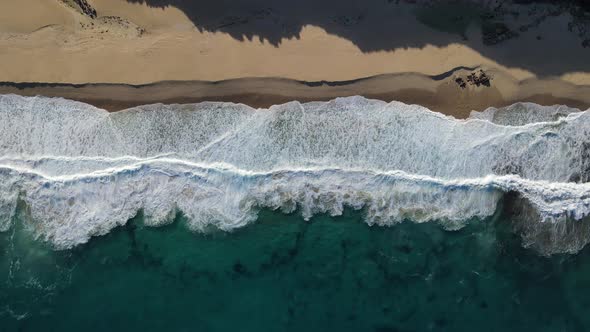 Topdown aerial calm wave action at Injidup beach Western Australia
