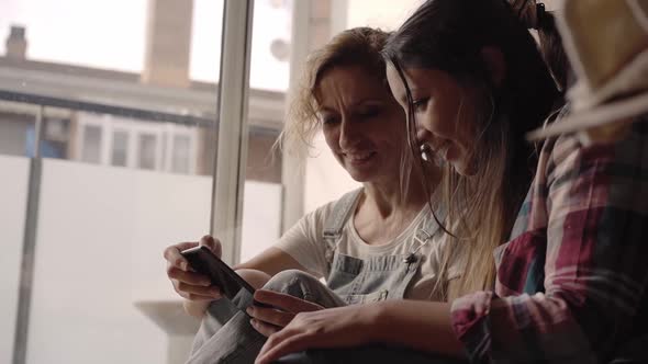 Closeup of Two Women Using a Smatphone at Home