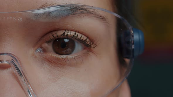 Woman with Protective Glasses Showing One Eye in Front of Camera