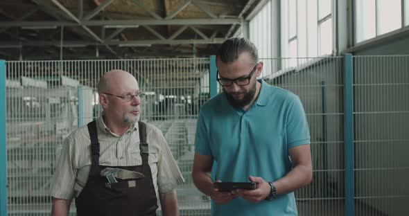 Engineers Walk at Manufacturing Facility on Factory