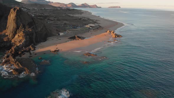 Picturesque summertime scenic flight above beautiful sandy beach of Calheta with ocean sea waves rol