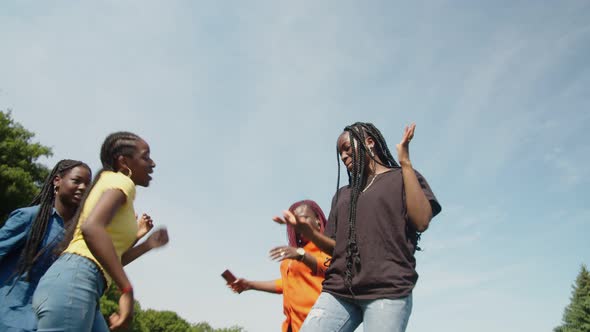 Graceful Cheerful Black Teenage Girls and Mom Dancing on Green Lawn