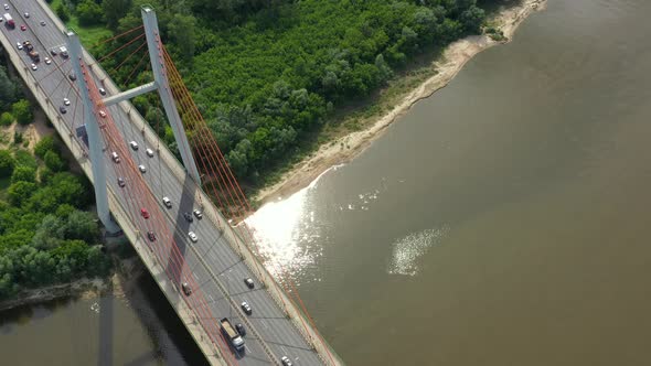 Aerial or top view from drone of concrete bridge with asphalt road or highway over big river with ci