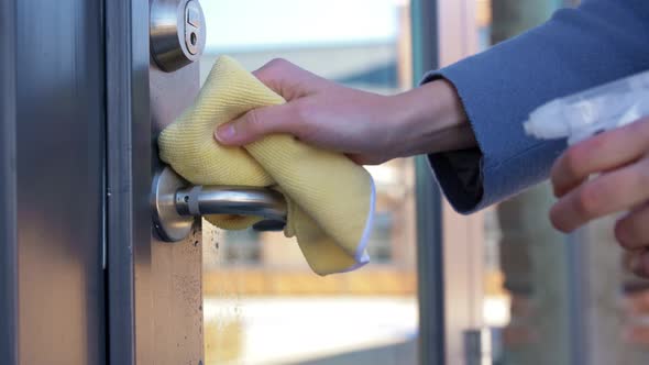 Hand Cleaning Door Handle with Detergent and Rag