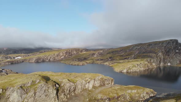 Glacial lake meltwater and rock hills, Hardangervidda, Norway subarctic, aerial