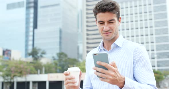 Man hold with mobile phone and drink of coffee