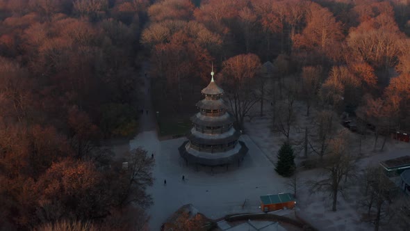 The Chinese Tower in Autumn in English Garden in Munich, Germany Surrounded By Beautiful Orange