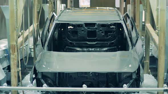 Car Body Being Dipped Into a Chemical Solution