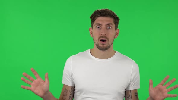 Portrait of Confident Frustrated Guy Is Saying Wow with Shocked Facial Expression. Green Screen