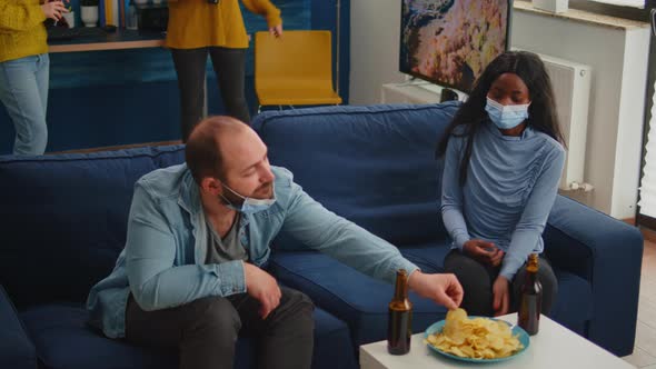 Group of Diverse Friends with Mask Meeting in Home Living Room