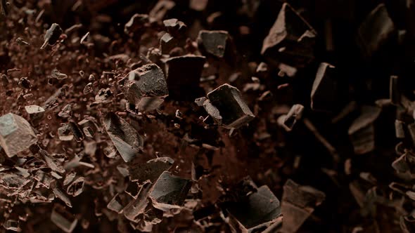 Super Slow Motion Shot of Raw Chocolate Chunks and Cocoa Powder Flying Towards Camera at 1000Fps