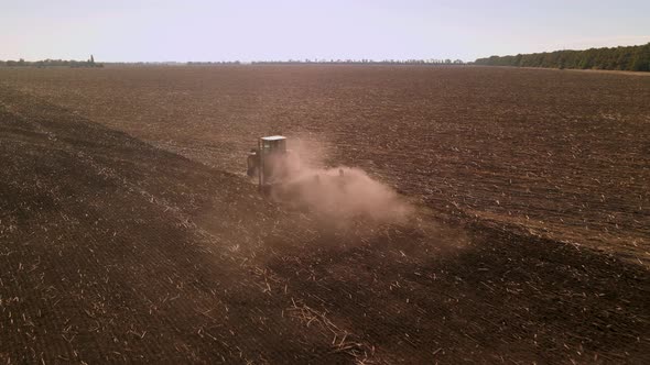 Slow Motion Drone View of Tractor Plowing Farm Field