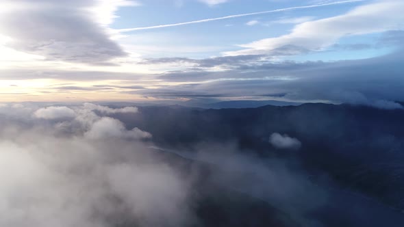 Aerial of Mountain Top Surrounded by Clouds 02