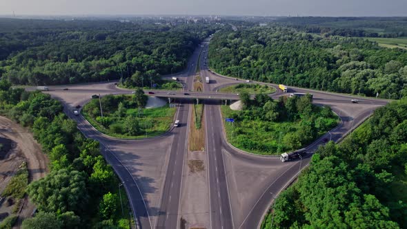 Traffic Driving Over Roundabout with Highway Road Underneath