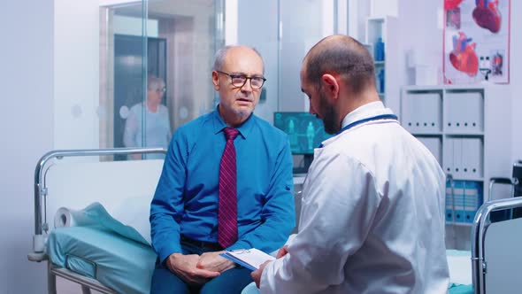 Senior Man Consulting with Doctor