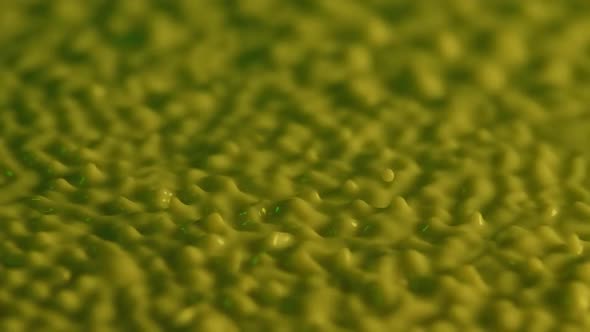 Macro Shot of Vibrating Spherical Drops of Yellow Milk