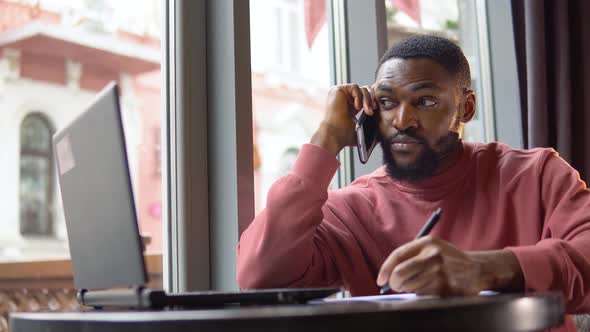 Man Doing Notes During His Busines Conversation