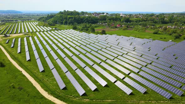 Aerial View of Big Sustainable Electric Power Plant with Many Rows of Solar Photovoltaic Panels for