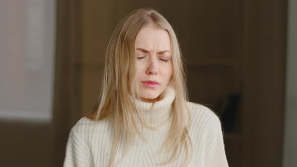 Portrait of Caucasian Millennial Blonde Girl Standing Indoor Looking at Camera Shaking Her Head