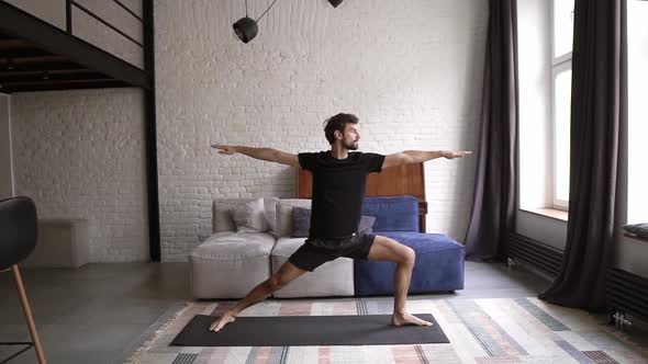 Man Practice Warrior Yoga Pose in Own Living Room on Mat