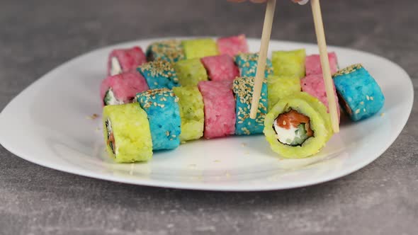 The Original Preparation of Traditional Japanese Sushi. Blue and Pink Rice Rolls Stuffed with