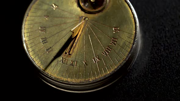 Solar Vintage Clock Rotate. Black Background. Close Up