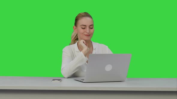 Positive Businesswoman Ready To Work on Laptop Computer at the Begining of Day on a Green Screen