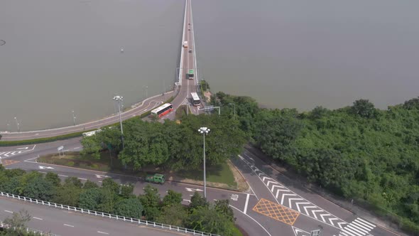 Aerial drone shot tilt reveal of Macau skyline and Praia Grande bridge