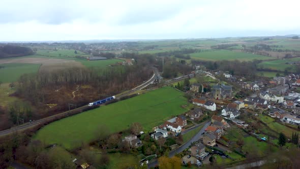 serie of 2. Drone flight over Schin op Geul, Village in the Netherlands wher a train is ariving at t