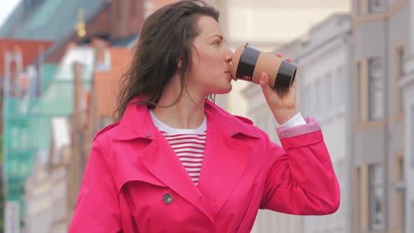 Attractive Woman Drinking Coffee and Enjoying City View