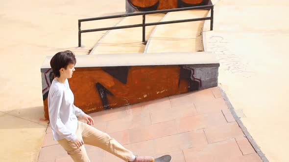 Teenage Girl Riding on Skateboard in a Skatepark