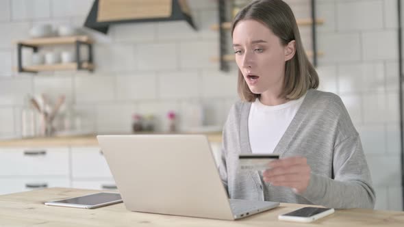 Unsuccessful Young Woman Using Credit Card on Laptop
