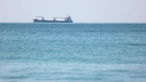 Large Barge Swiftly Sails Across the Sea.