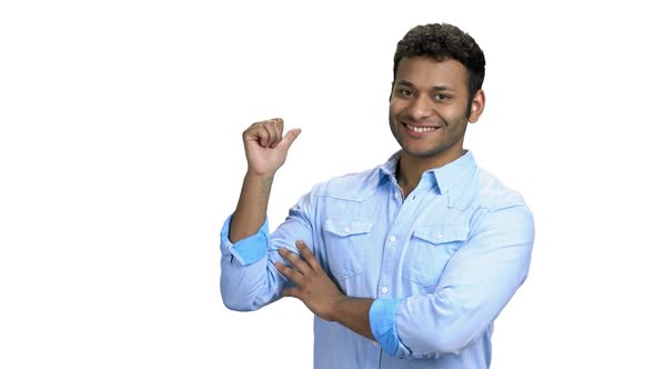 Indian Man Pointing with Thumb at Copy Space