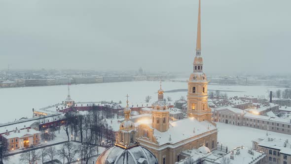 Aerial Footage of the Peter and Paul Fortress in a Snow Storm in a Winter Evening Night Illumination