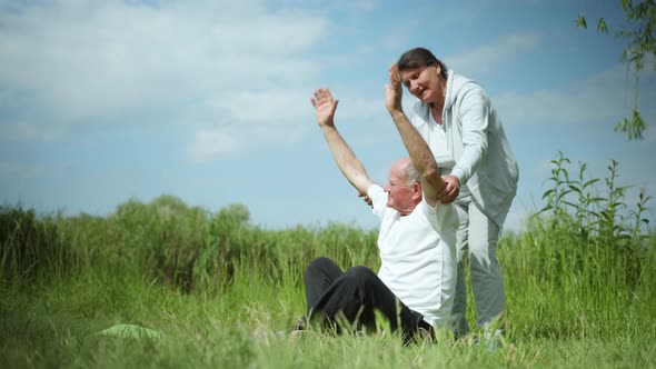 Yoga and Meditation, Caring Old Wife Helps Her Beloved Elderly Husband Perform Body Health Exercises