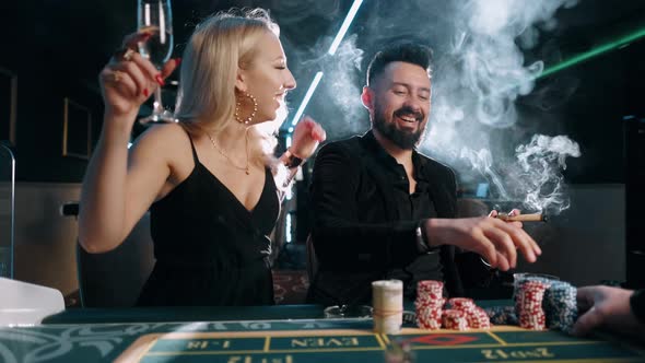 Beauty Young Women and Bearded Man Are Winning and Rejoice in Victory at the Casino