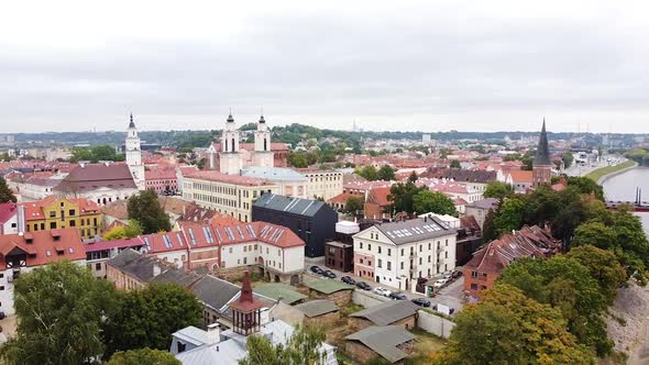 Colorful rooftops of Kaunas city, aerial side flying view