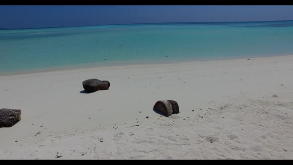 Aerial top down nature of marine tourist beach holiday by aqua blue sea with white sandy background 