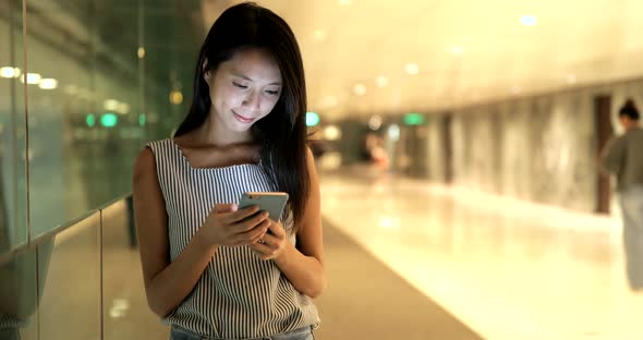 Woman using cellphone and walking in the city 