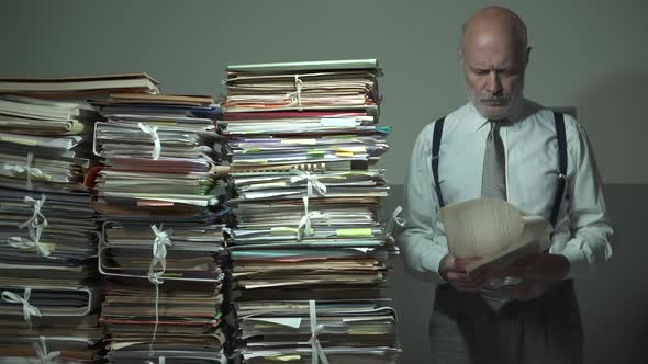 Corporate businessman and piles of paperwork