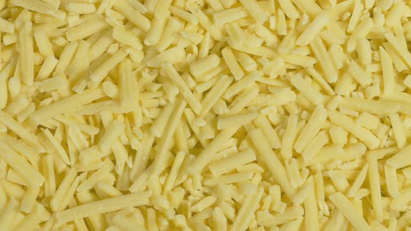 Plate Of Grated Cheese Turning Top Down View