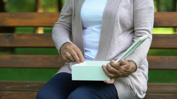 Woman Looking at Necklace With Smile, Valuable Gift From Loved One, Sad Memories