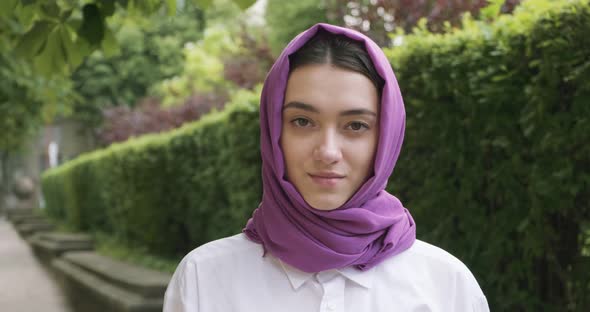 Beautiful Young Woman Looking at Camera, Wearing Traditional Headscarf. Attractive Female in Hijab