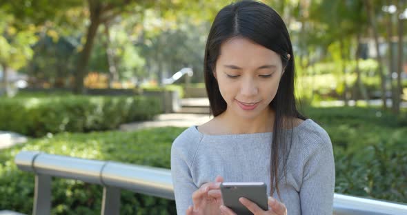 Woman use of mobile phone in the park