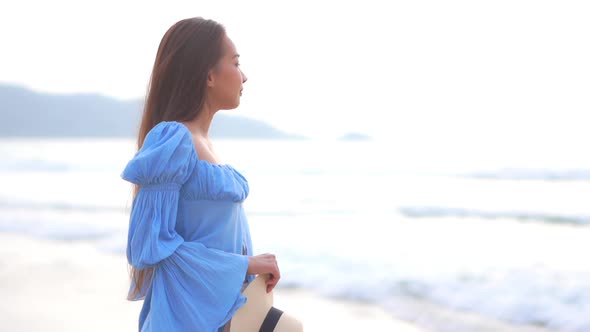 Asian woman enjoy around beautiful beach sea ocean